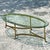 Elevate your living space with the timeless elegance of this Vintage Regency Oval Brass Claw Foot Coffee Table. Perfect...