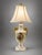 Elegant vintage Victorian-style table lamp featuring an ornate cream and white urn-form body with gold-tone scrolling...