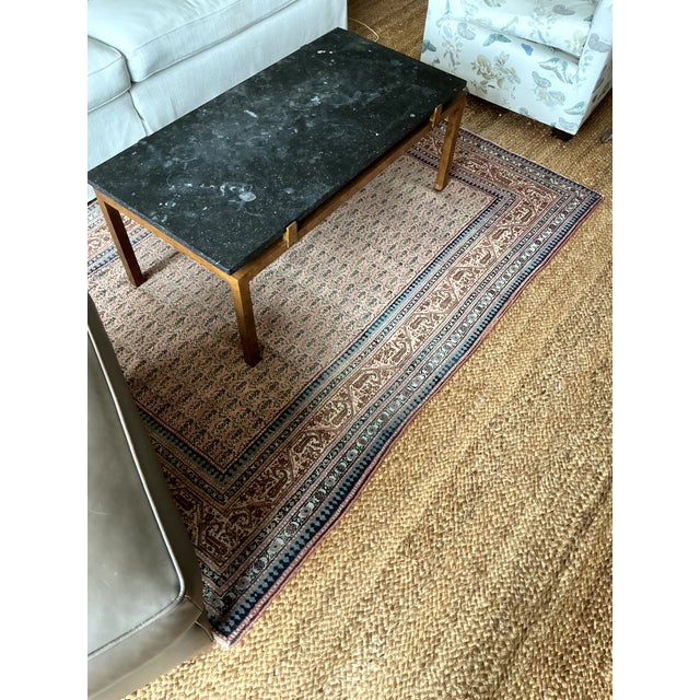Black Belgium stone top coffee table with patinated gold/ brass legs