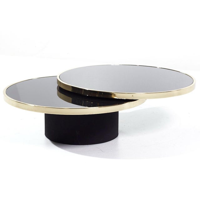 Attributed to Institute of America brass and smoked glass swivel cocktail table with black base (similar to Gabriella...