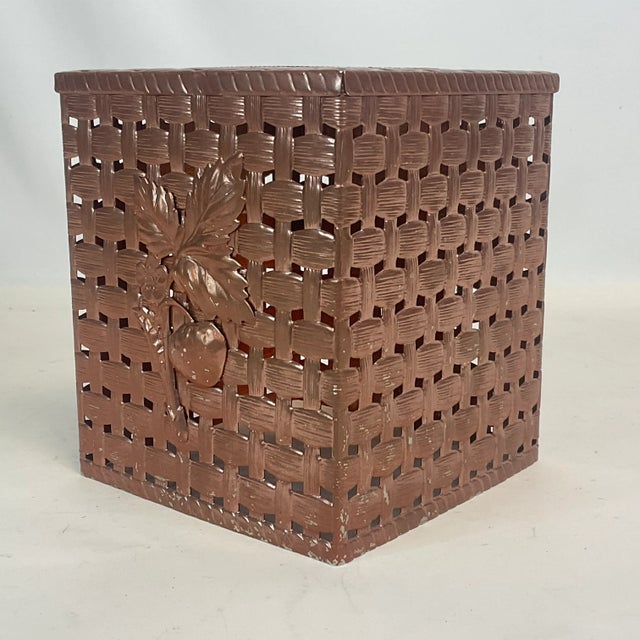 This is a lovely mid-century metal tissue box cover. The design features a faux woven basket and a branch if strawberries...