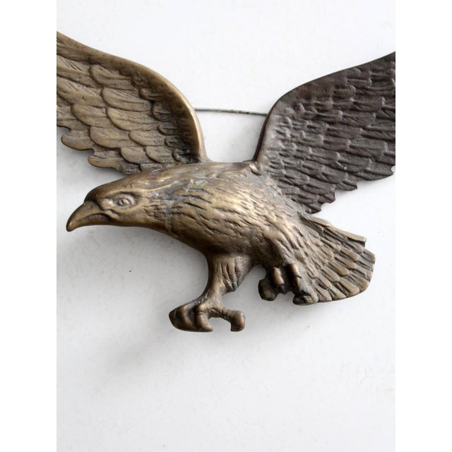 This vintage metal eagle wall hanging features an American eagle with outstretched wings and detailed featherwork. A bold...
