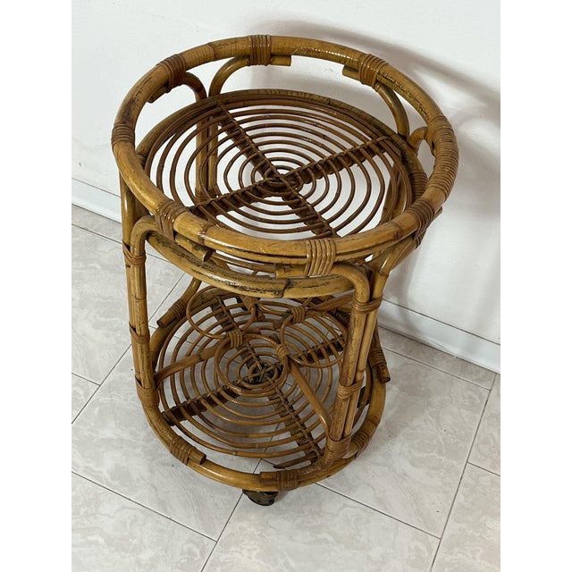 Mid-century circular bamboo bar cart in the style of Franco Albini, Made in Italy, 1960s It is equipped with wheels, in...