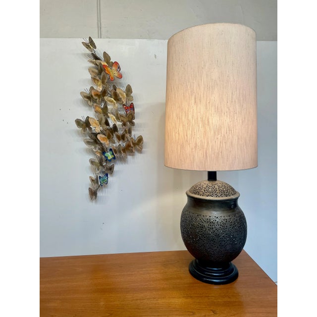Hollywood Regency intricate brass table lamp with floral design cutouts. This fabulous tall lamp measures 50" from bottom...