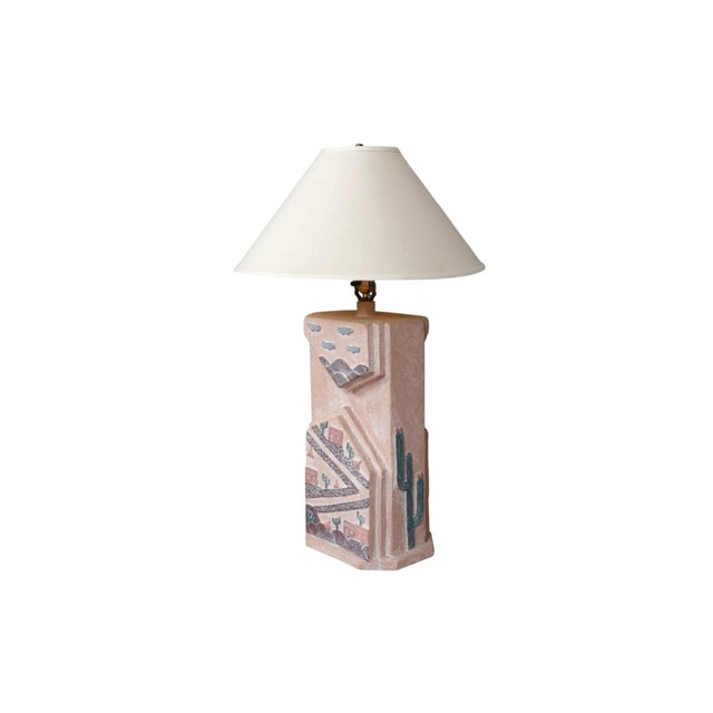 A rectangular southwestern earthenware table lamp. Hand crafted and decorated with a pink finish, embossed and engraved on...