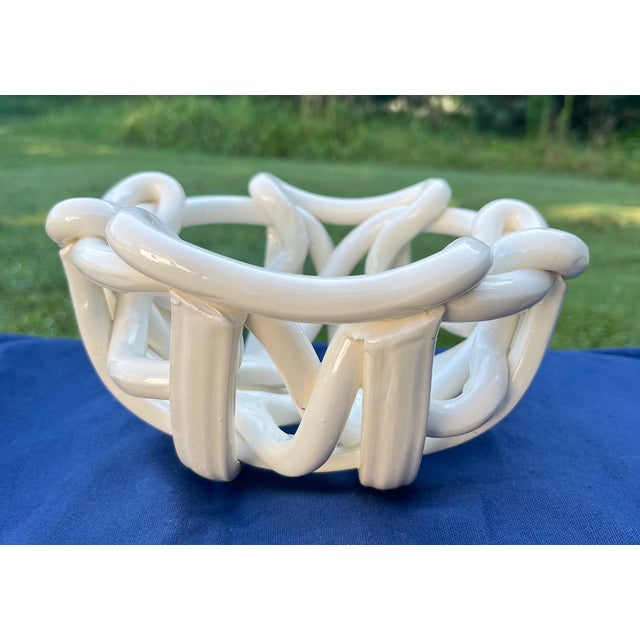Unique ceramic abstract bowl or centerpiece made with a free flowing, woven design in a creamy off-white color with a...