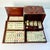 This is a lovely antique Mahjong Game Set. It features tiles that have bamboo backs with bone fronts. The tiles are...