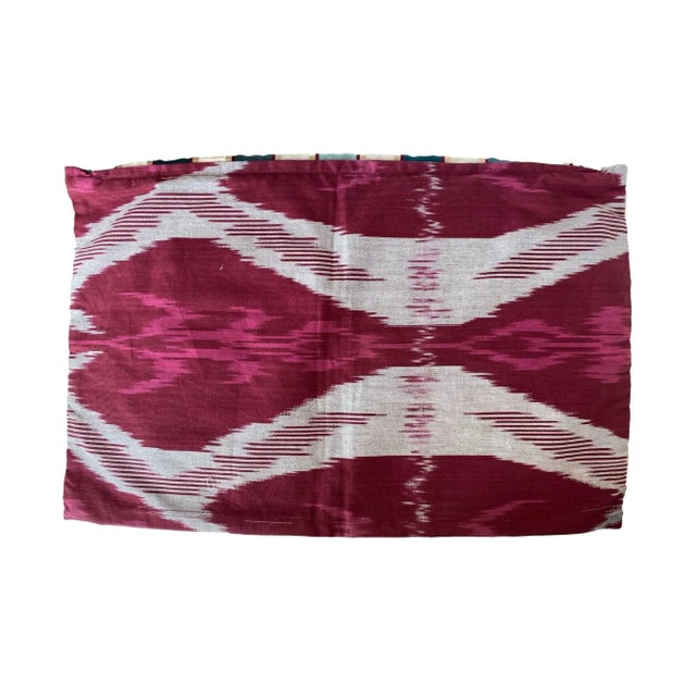 The front of this pillow features silk vertical stripes in shades of teal, white, gold, and subtle burgundy accents,...