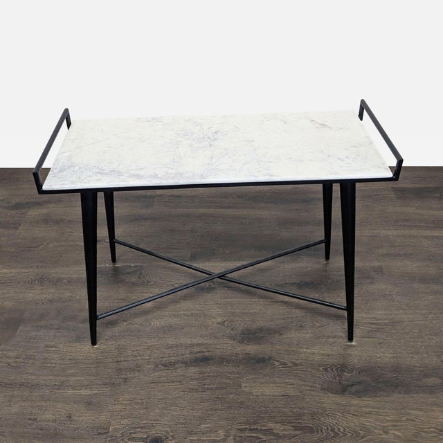 This rectangular console table features a smooth marble tabletop in white with raised black metal handles on the sides,...