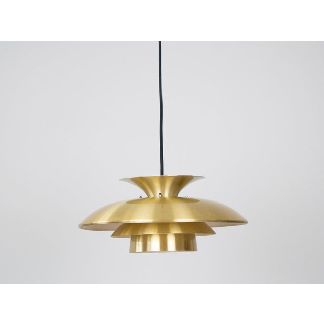 The lamp's form was designed based on the principle of a reflective system that directs light not only downward but also...