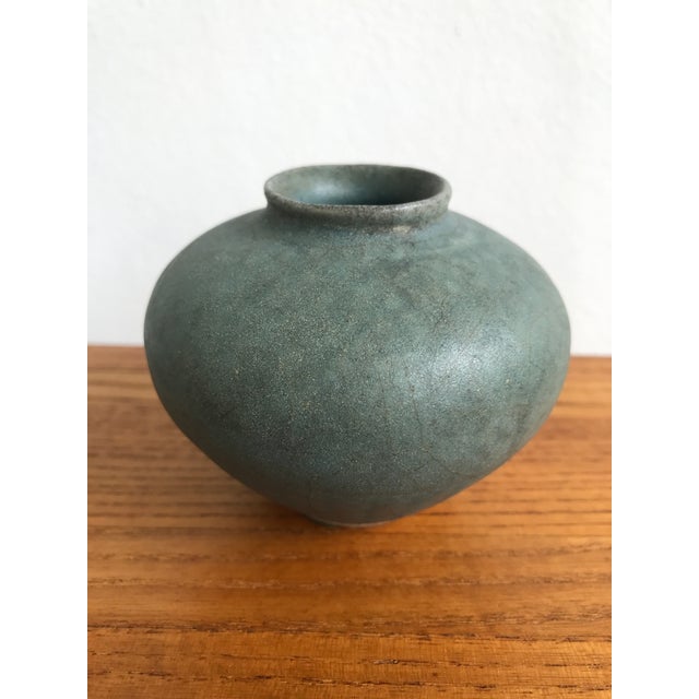 This lovely antique miniature celadon pot features a fabulous petrol blue shade glaze. The traditional bulbous form is...