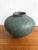 This lovely antique miniature celadon pot features a fabulous petrol blue shade glaze. The traditional bulbous form is...