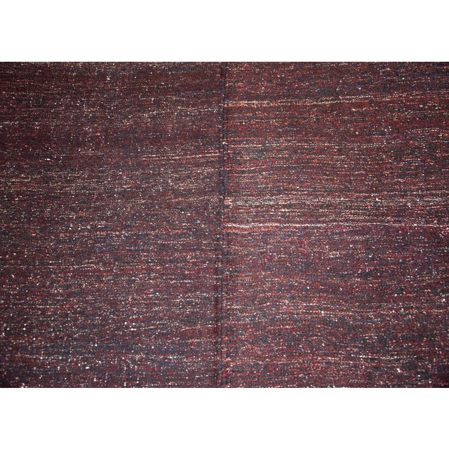 A chic and modern mid-20th century Persian Gabbeh kilim rug woven in with indigo nd crimson wool in large color blocks...