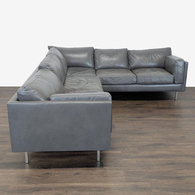 This BenchMade Modern sectional features a sleek L-shaped design in a stylish gray leather finish. The spacious seating...