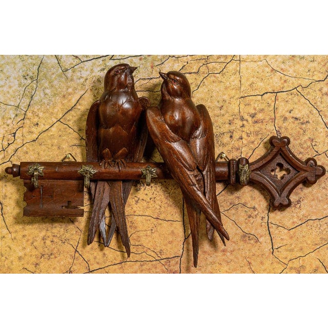 German Black Forest wall key holder, early 20th century. Hand-carved linden wood key hanger featuring a pair of swallows...