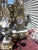 Striking vintage three-piece Imperial clock garniture set consisting of an ornate mantel clock and two matching multi-arm...