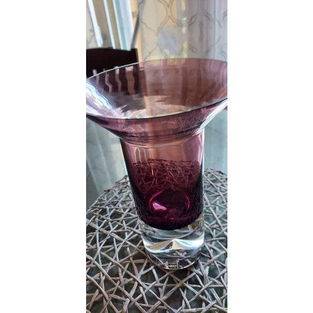 Elegant in it's clean lines, interesting with it's thick clear base, this vase is 11 inches tall with a 7 inch opening....