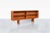 Danish modern teak credenza / bookcase designed by Bernhard Pedersen in Denmark, circa 1960s. Showcasing the refined...