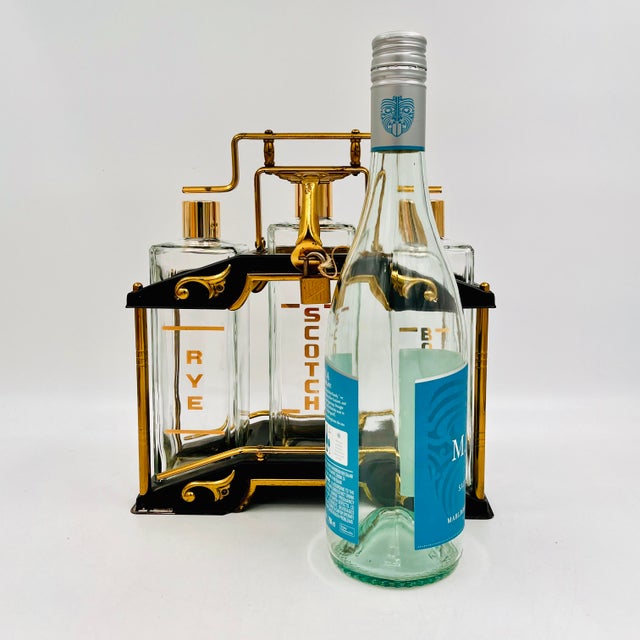 Vintage Mid-Century Modern locking tantalus decanter set. Also known as a liquor caddy or portable bar, featuring three...