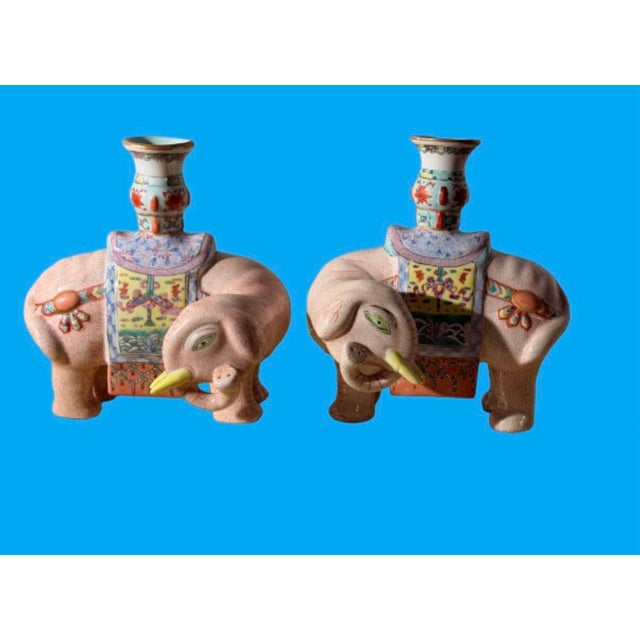 A pair of Chinese export famille Rose enameled porcelain elephant candlestick holders features hand painted floral...