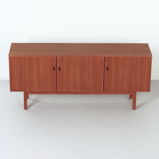 Vintage teak sideboard with curved wooden drawer from the 1960s. Dutch design with plenty of storage space, black metal...