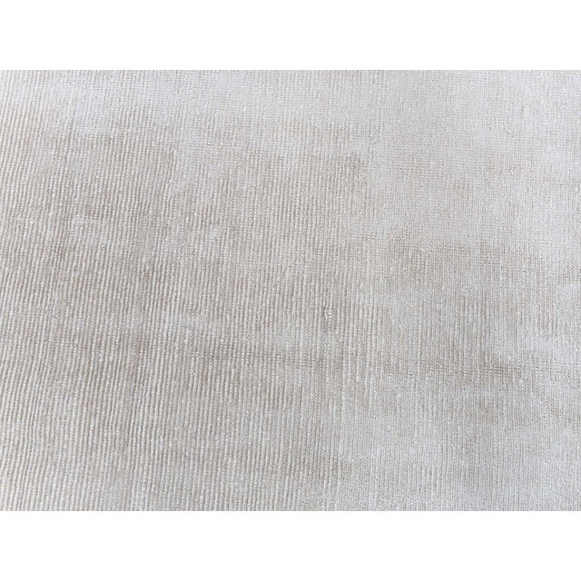 The Modern Silk Line Grip Rug is a serene study in subtle luxury and refined texture. Hand-knotted with an opulent silk...