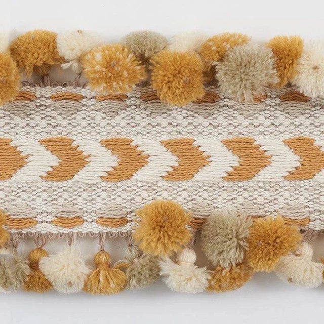 Inspired by traditional Peruvian textiles, Maracana Pom is a dimensional woven trim with playful, multi-colored pom-poms....