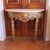 A stately Italian Neoclassical demilune console table with a wonderful carved apron centered on a bold rosette medallion...