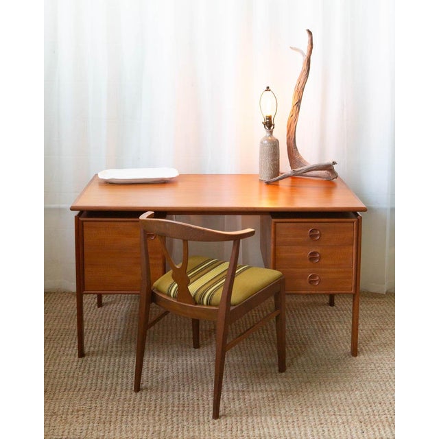 Elegant mid-century desk designed by Arne Vodder in the 1960s. Crafted in warm Danish teak, it features beautifully...