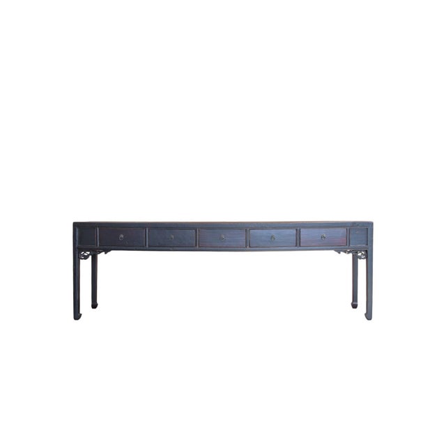 This 19th century console table features an exceptionally long, narrow silhouette finished in a rich, dark lacquer that...