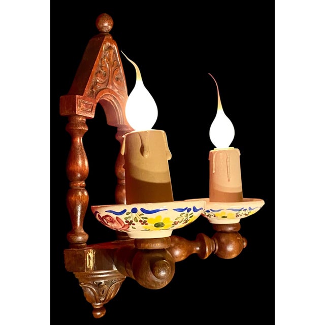 An antique, circa 1915 French Black Forest/Arts and Crafts electrified double candle wall sconce with hand carved walnut...