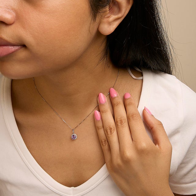 Adorn your neckline with the exquisite allure of this 10K white gold pendant necklace, where the warmth of the metal...