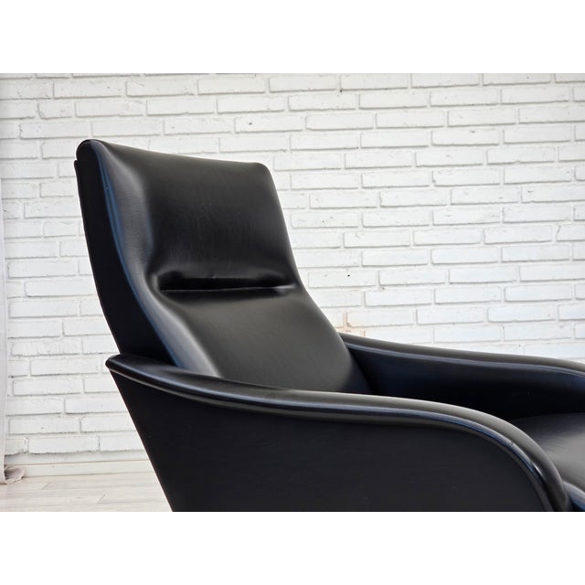 1970s, Danish armchair. Black artificial leather, teak wood legs. Original good condition: no smells, no stains and stable...
