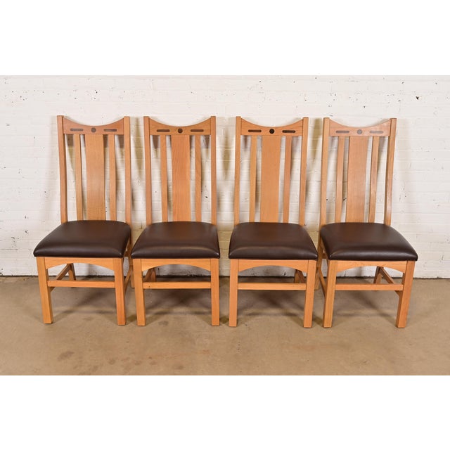 An exceptional set of four Mission or Arts & Crafts style high back dining chairs In the manner of Stickley or Charles...
