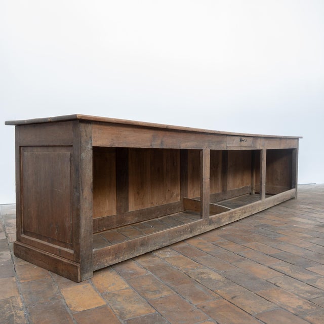 An exceptional antique 19th-century fir shop counter, remarkable for its particularly generous dimensions and the...