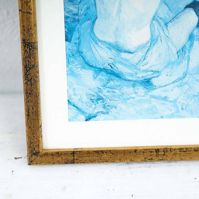 Reproduction print of Toulouse Lautrec's painting in a gold frame.