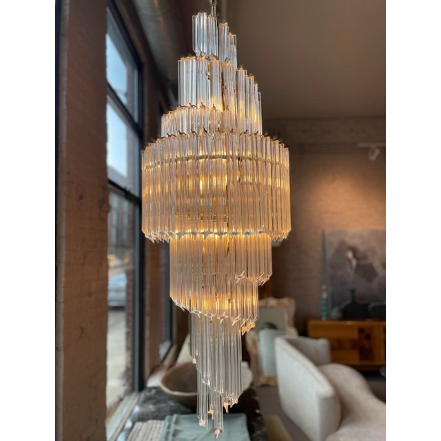 Beautiful chandelier in lucite that looks glass. Perfect for a double ceiling height entry! This is currently hanging in...