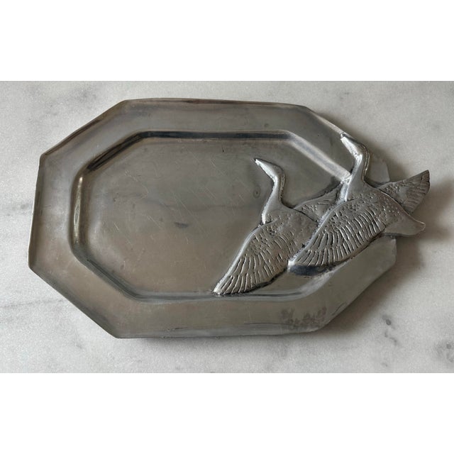 Vintage metal (believed to be pewter) octagonal platter with flying geese. The platter has raised edges and is perfect for...