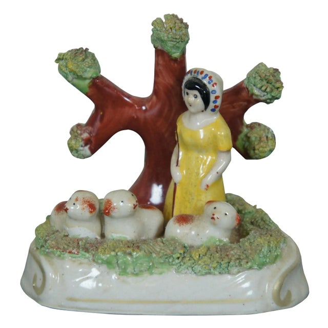 Pair of antique early Staffordshire pearlware bocage figures, a shepherd and a shepherdess each standing in front of a...