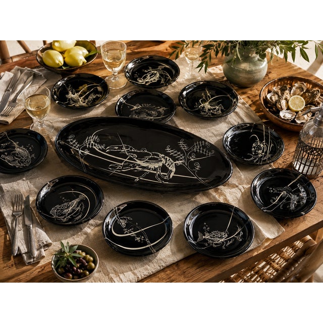 This fish service set dating from the middle of the 20th century, manufactured by the Vallauris factory, offers a...
