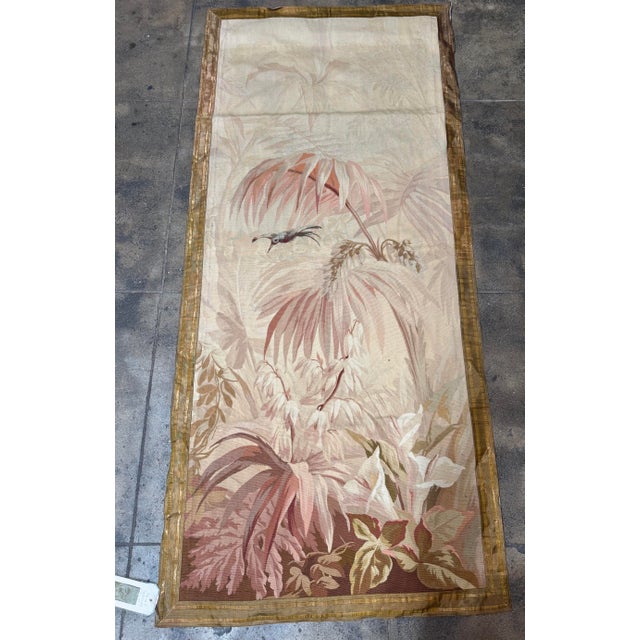 An elegant nineteenth century French needlework tapestry depicting a tranquil verdure scene with layered foliage, soft...