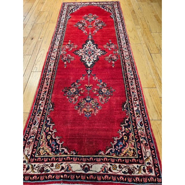 "Vintage Persian Hamadan Wide Runner, a truly magnificent hand-knotted piece. The runner features a brilliant red color...