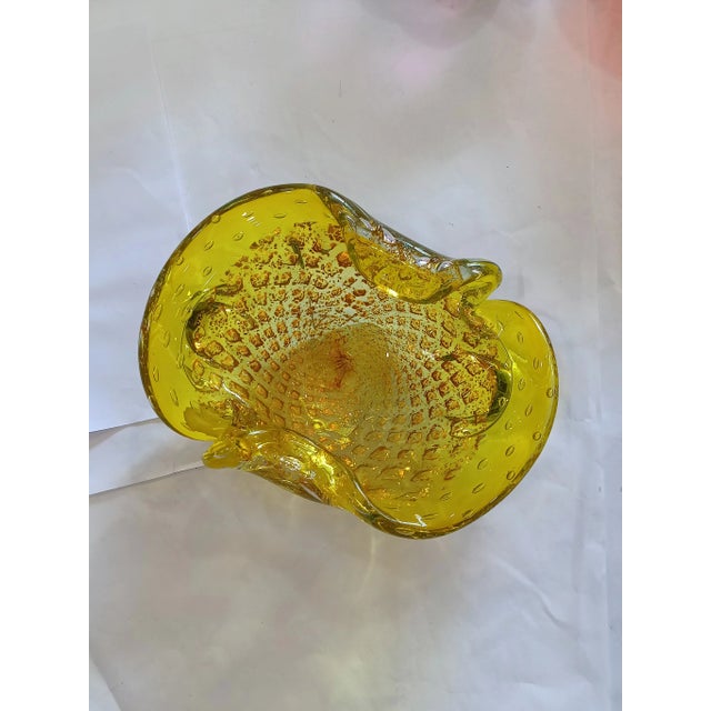 Vibrant yellow hand-blown glass ashtray, Murano-attributed, featuring the classic Bullicante controlled bubble technique...