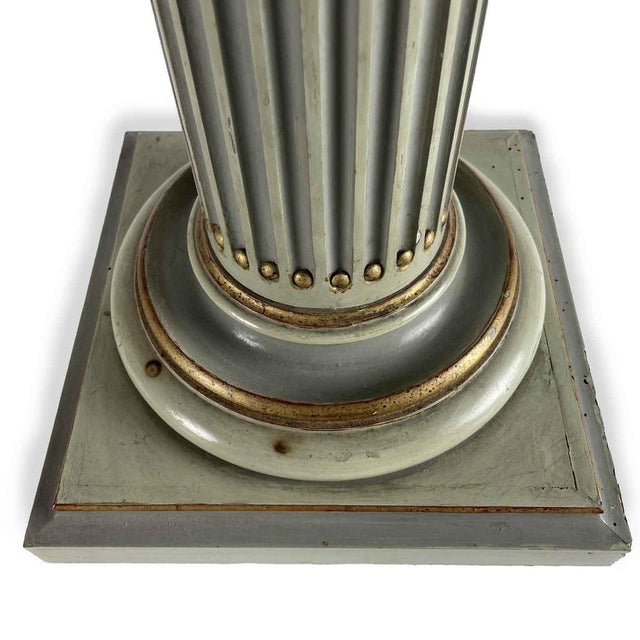 Pair of 20th-Century Light Green Lacquered Columns, two columns with Doric capitals featuring carved and gilded elements,...