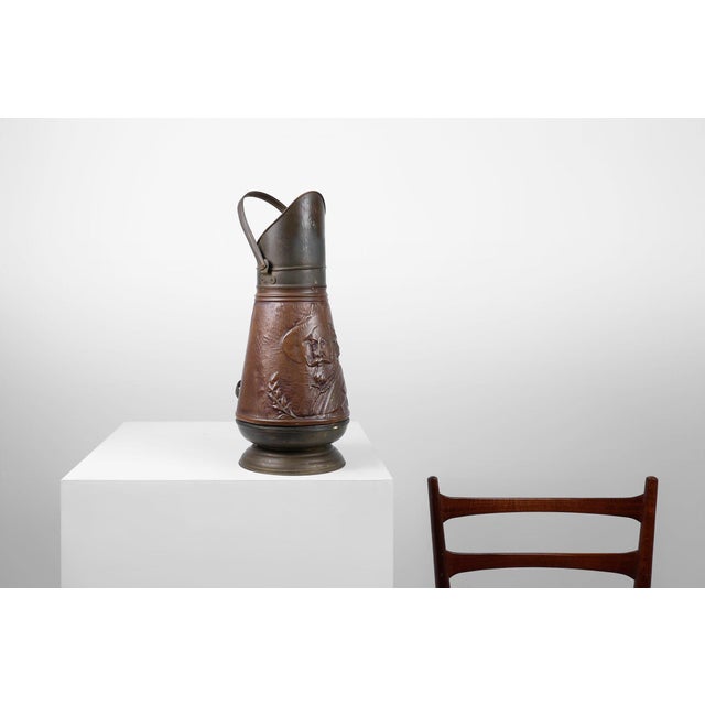 A striking French copper coal bucket, crafted around 1900, now serving beautifully as a decorative umbrella stand. The...