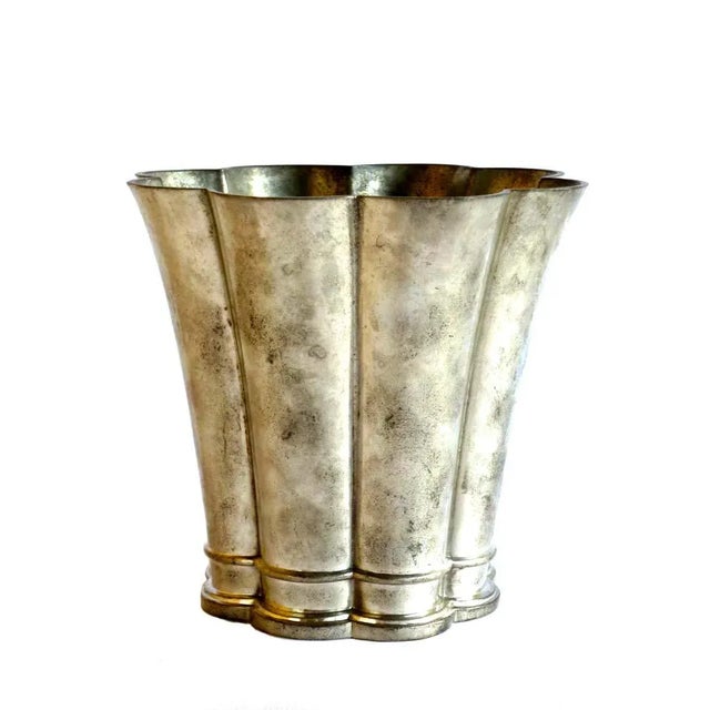 This metal vase or pot is embossed with the make Just Andersen on the base. Imprinted by Maker,This piece has an...