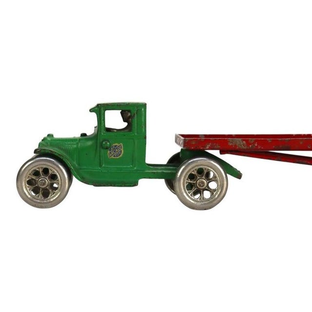 A notable six-piece antique toy set by Arcade, dating to approximately 1920. This collection features a green cast iron...