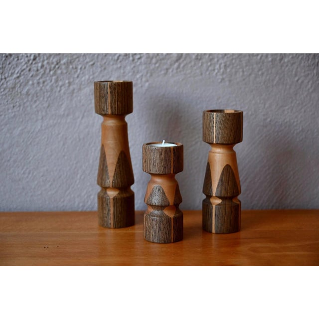 Discovered in Denmark, this lovely set of two-tone wooden candlesticks will delight lovers of cozy, Hygge-inspired decor....