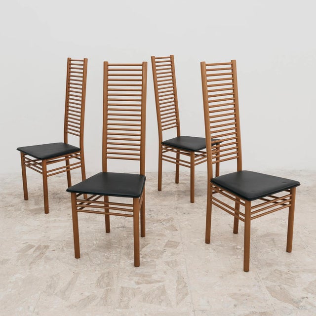A splendid and elegant dining set consisting of four original vintage chairs from the 1980s, featuring a slender,...