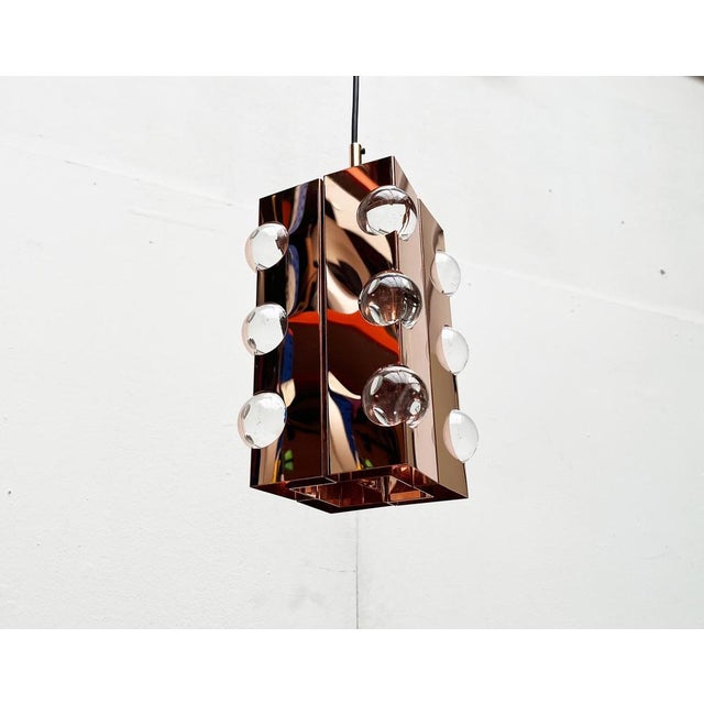 Imposing pendant lamp in Cosack copper. This lamp convinces with its materiality and the associated, complex reflections...